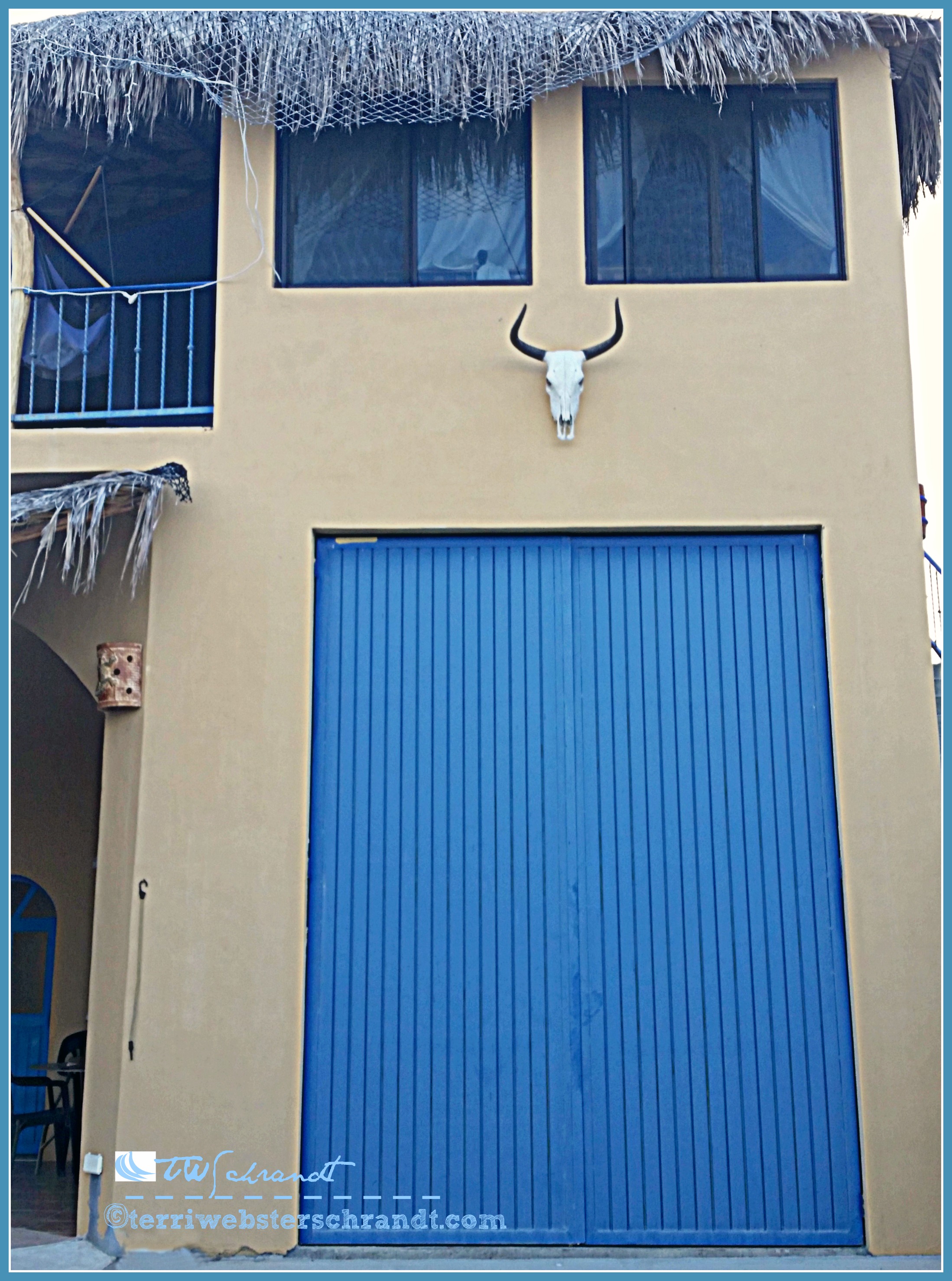 Large, blue garage door graces this fabulous retirement villa in Baja.