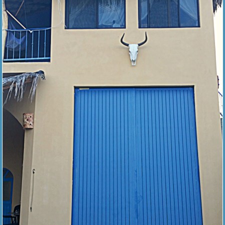 Large, blue garage door graces this fabulous retirement villa in Baja.
