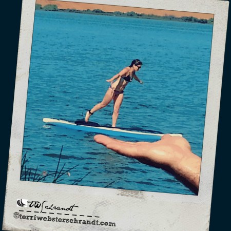 Holding his daughter in the palm of his hand