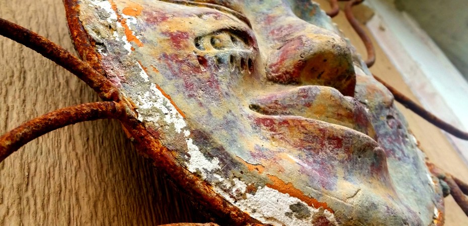 Metal Aztec sun showing a little rust