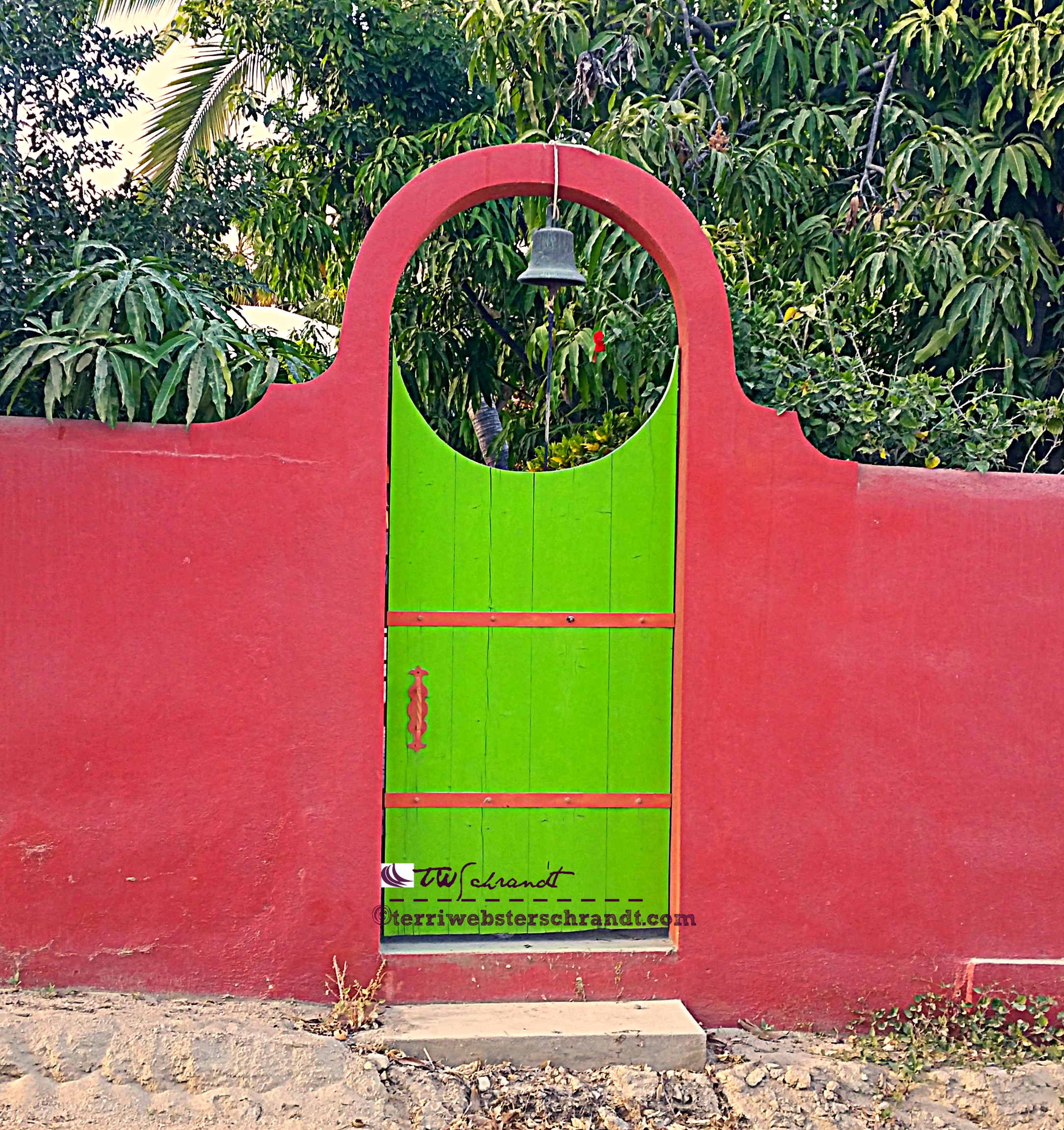 Vibrant gate guards a homey villa in Baja, Mexico.