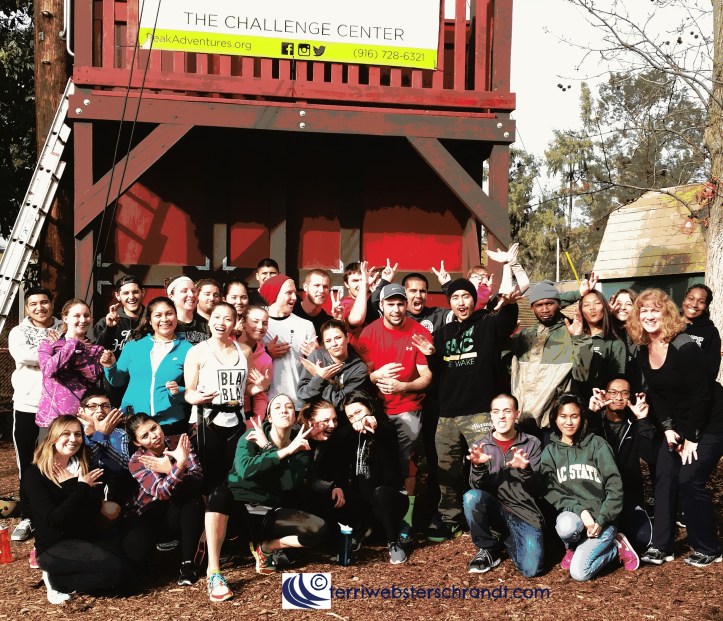 Happy students pose for a group photo after a day on the challenge course