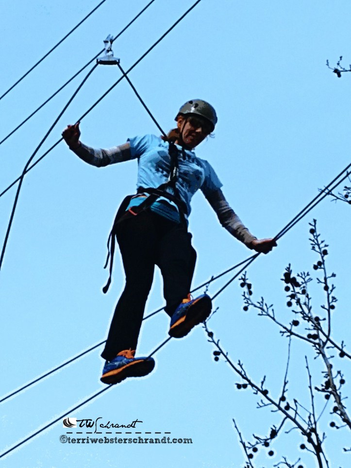 Students close-up of 40-feet high tightrope shows determination and motivation.