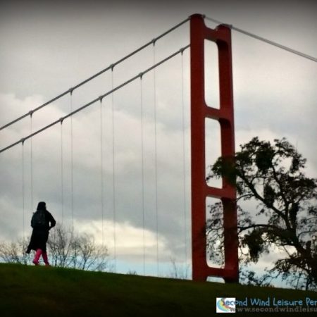 Solitary students walks the levee toward the bridge