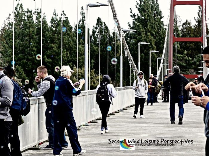 Bubble-blowing session in full swing as pedestrians cross the bridge