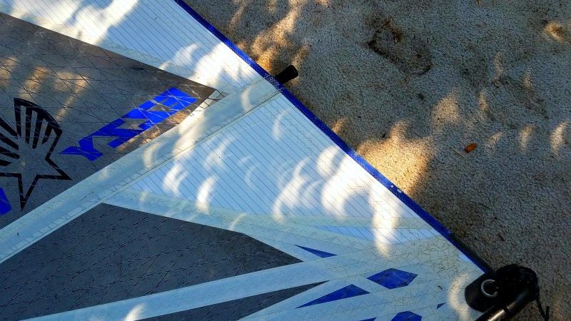 Partial solar eclipse leaves wondrous crescent shadows on a windsurf sail