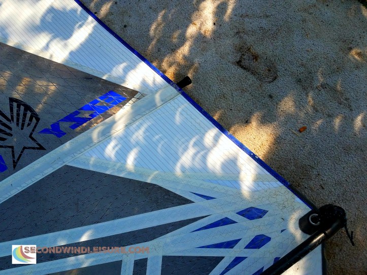 Partial solar eclipse leaves wondrous crescent shadows on a windsurf sail