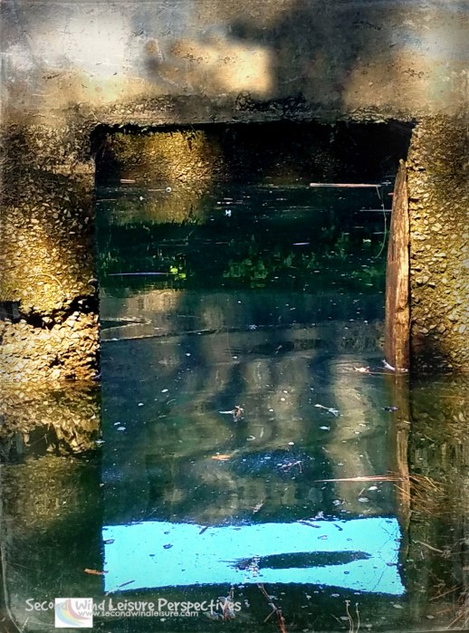Old pumphouse window partially submerged plays trick on the eyes