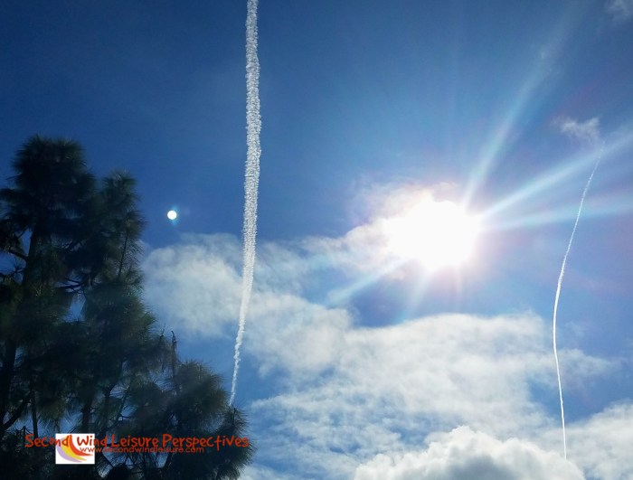 Temporary jet trails line the sky