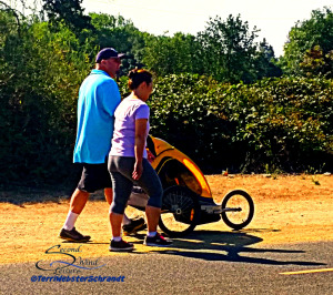 man and woman pushing stroller