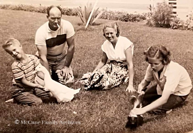 Family enjoying pet duck and skunk