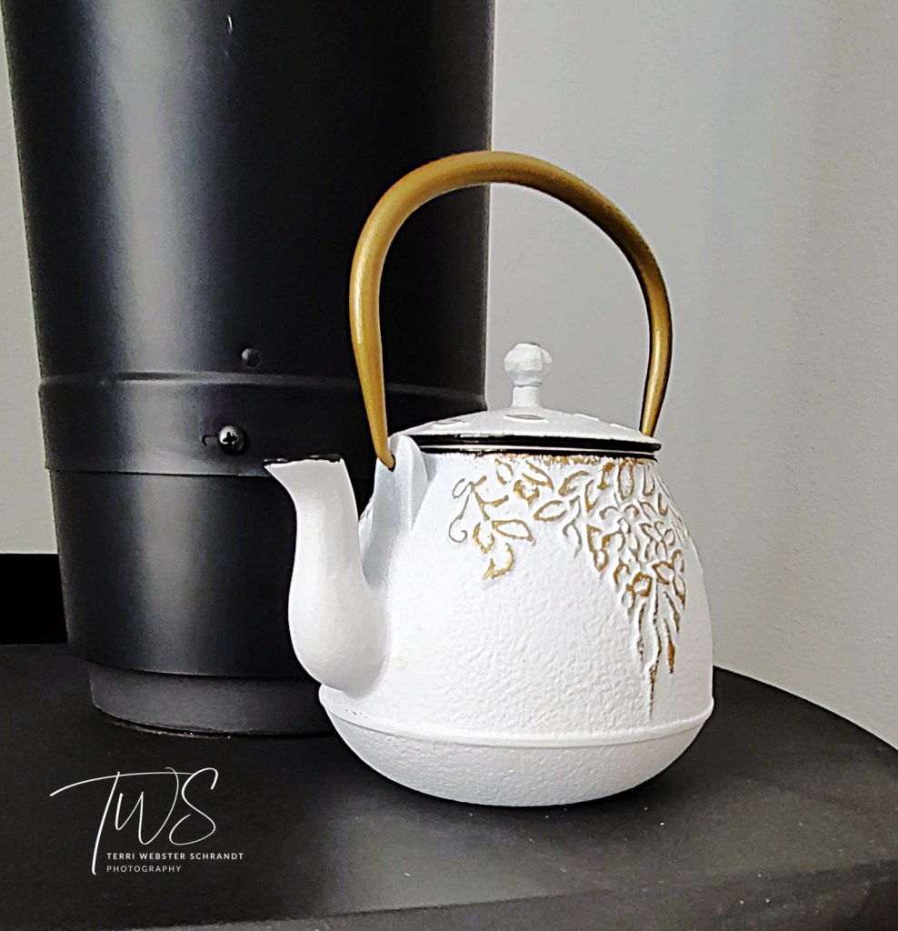 White Teapot on black stove