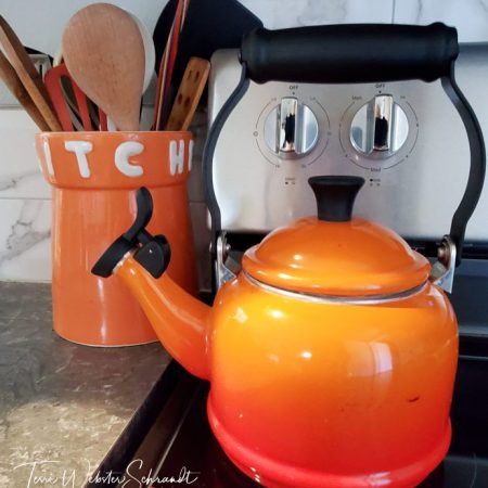 Smiling orange teapot