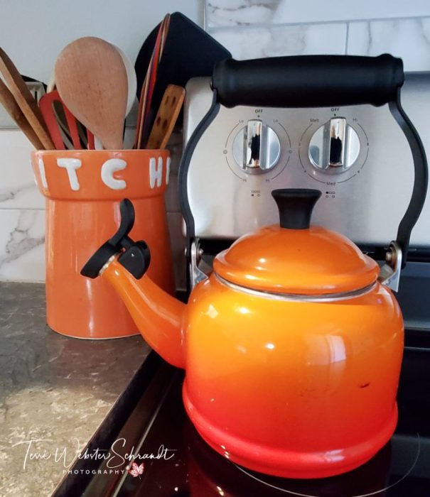 Smiling orange teapot