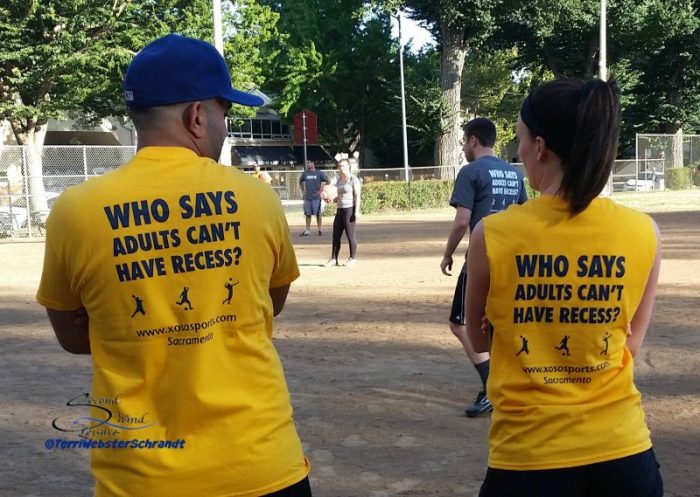 Adults playing kickball