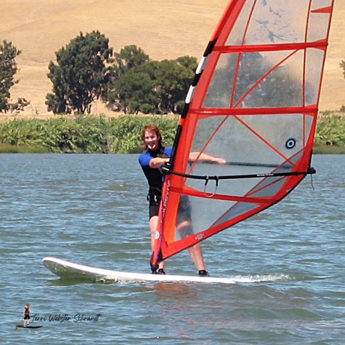 Woman Windsurfing Red Sail