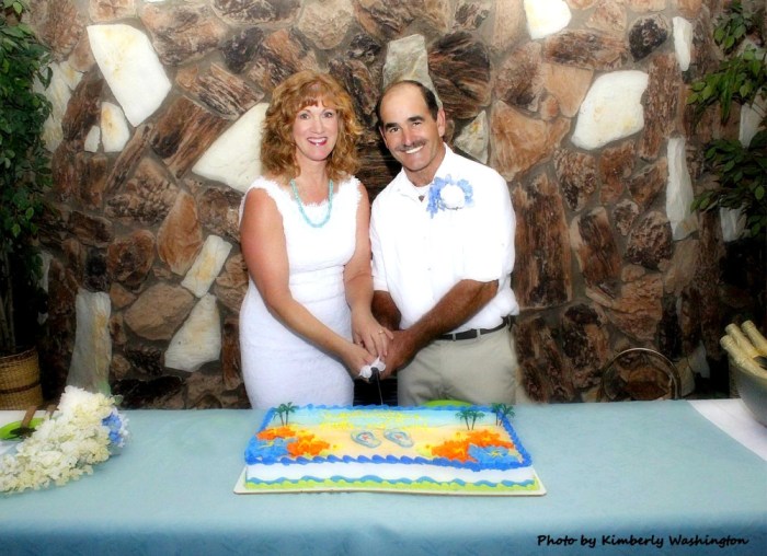 Couple cutting wedding cake