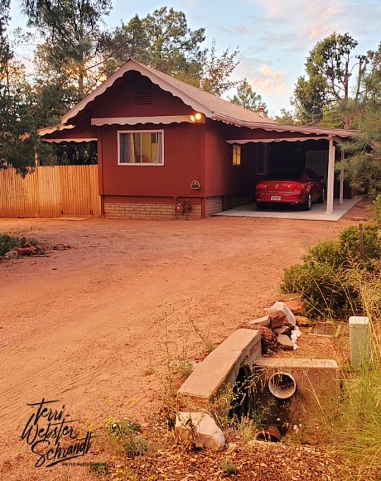 Maroon house with car