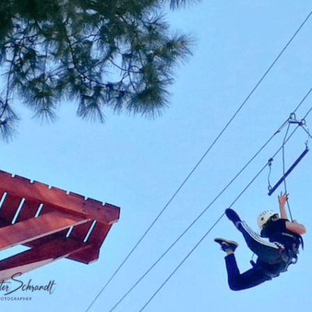 woman jumping toward suspended trapeze