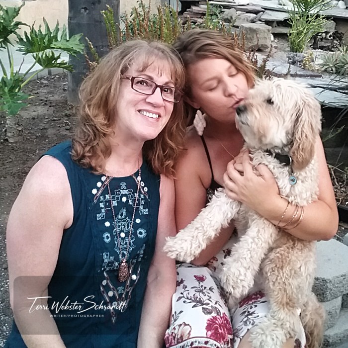 two women with white dog