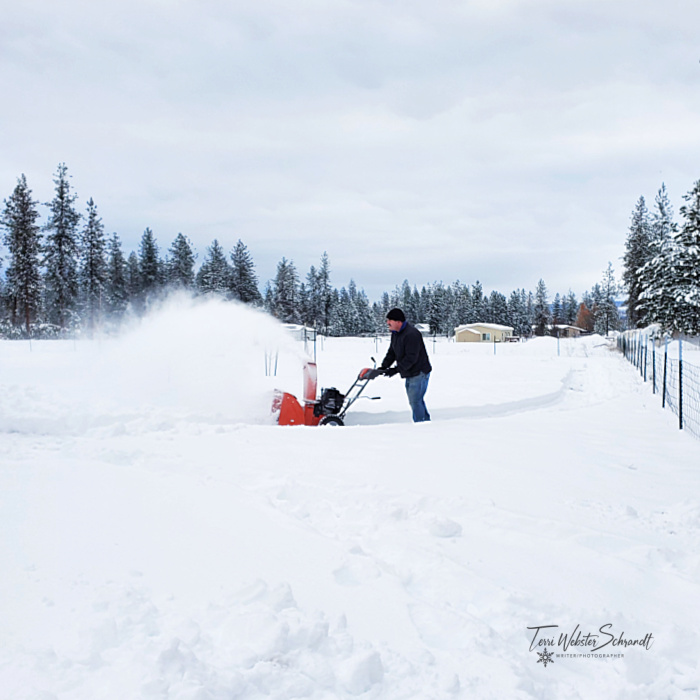 Man blowing snow